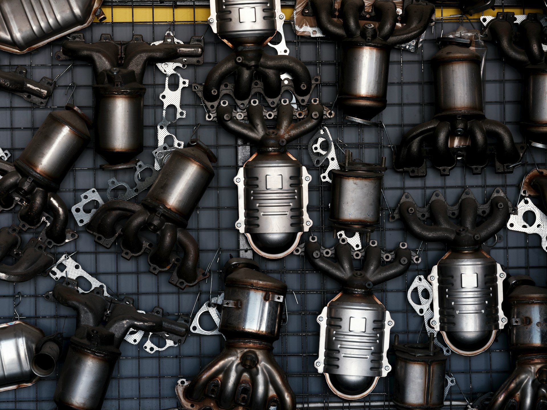 Collection of car exhaust catalytic converters and parts